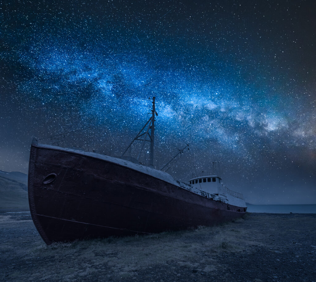 Shipwreck on the shore and milky way in Iceland