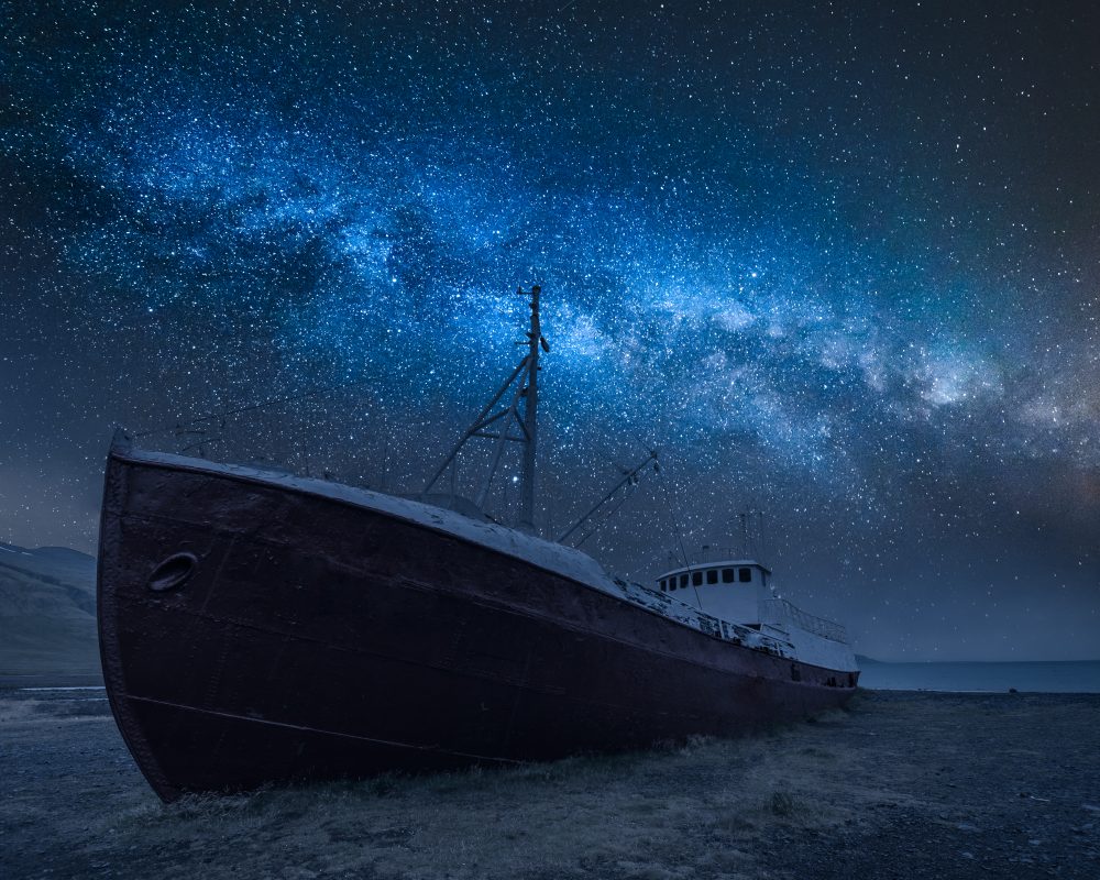 Shipwreck on the shore and milky way in Iceland